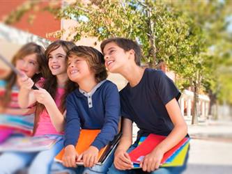 4 kids taking a selfie with a selfie stick