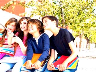 4 kids taking a selfie with a selfie stick